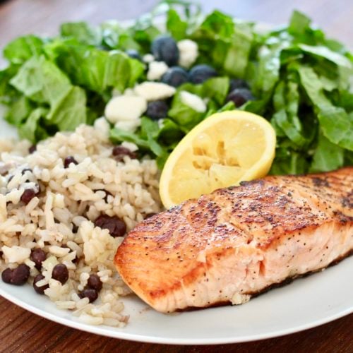 How to cook salmon 3 | Milk & Honey Nutrition pan fried salmon with rice and salad on white plate how to cook salmon