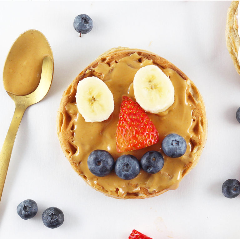 Homemade Toaster Waffles for Growing Kids | Milk & Honey Nutrition Homemade Toaster Waffles with a smiley face in fruit for Growing Kids