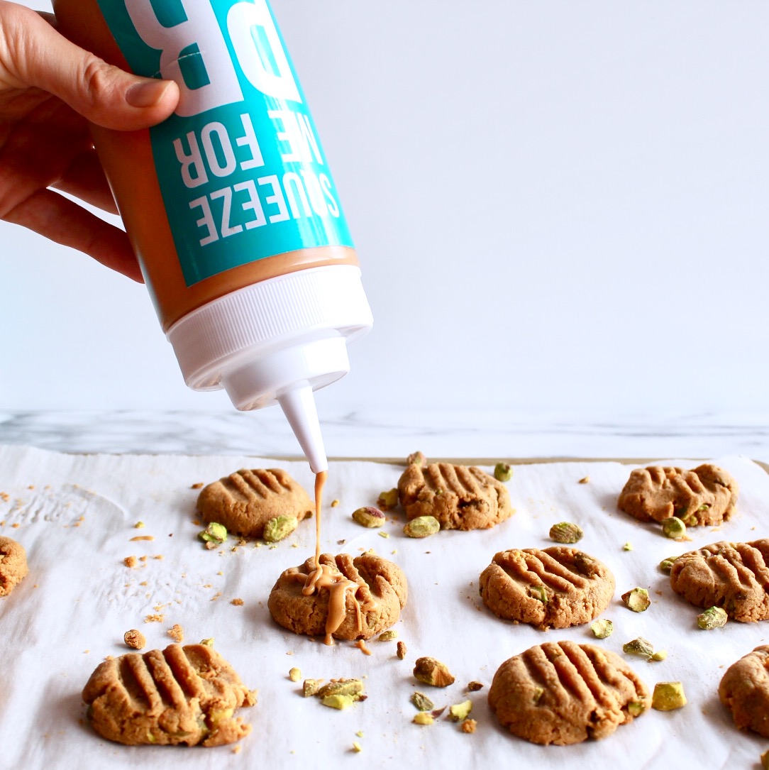 low carb peanut butter cookies with pistachios and drizzled peanut butter