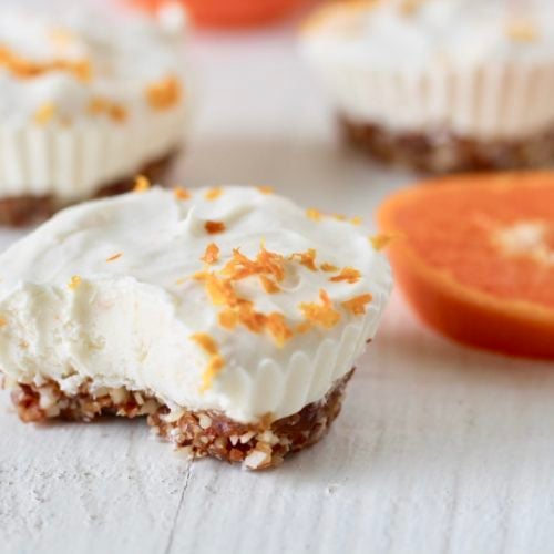 Orange No Bake Cheesecake Cups 3 | Milk & Honey Nutrition cheesecake cup with bite eaten healthy no bake desserts