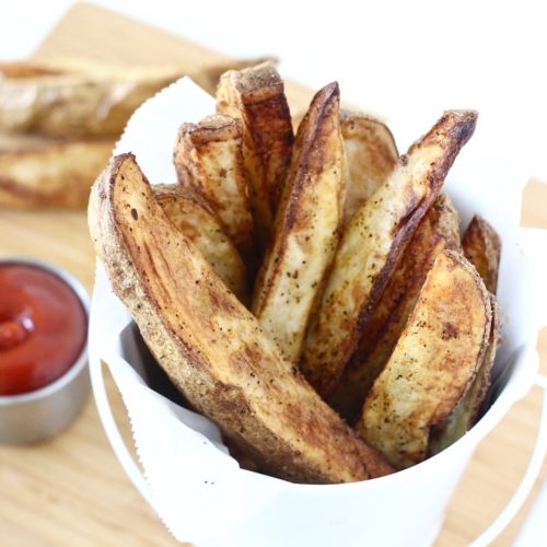 Perfectly Crispy Air Fryer Potato Wedges 5 | Milk & Honey Nutrition potato wedges in white bucket with ketchup