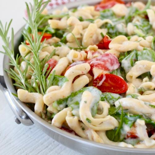 Creamy Chickpea Pasta with Spinach and Rosemary 6 | Milk & Honey Nutrition pasta dish in stainless steel skillet