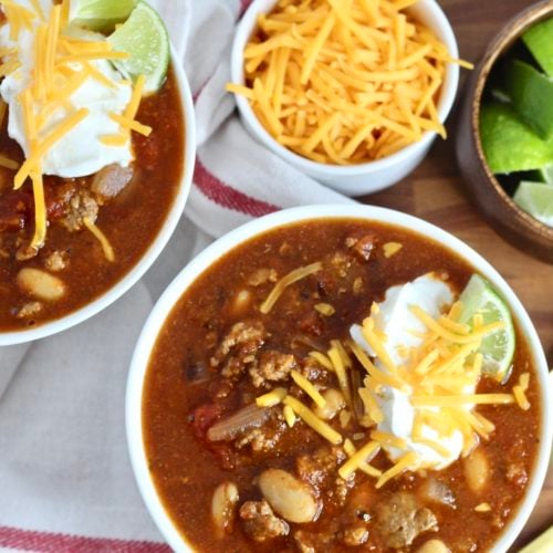 gluten free chili turkey 3 | Milk & Honey Nutrition gluten free chili with turkey cheddar cheese and limes in two bowls