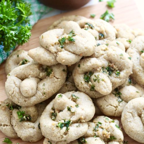 gluten free garlic knots 4 | Milk & Honey Nutrition gluten free garlic knots with [arsely on wooden cutting board