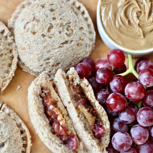 homemade uncrustables cut flat lay | Milk & Honey Nutrition california grapes and peanut butter with homemade uncrustables