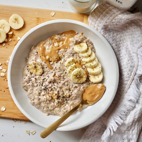 peanut butter overnight oats 16 | Milk & Honey Nutrition banana peanut butter overnight oats in white bowl with kefir