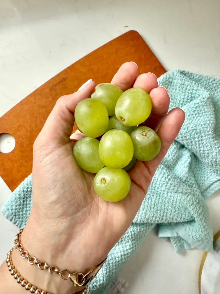 green seedless grapes in hand